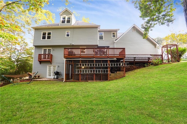 back of house with a deck and a lawn