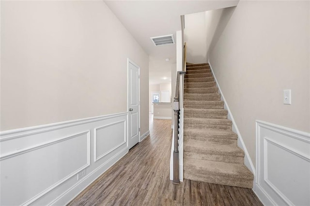 stairway featuring wood-type flooring