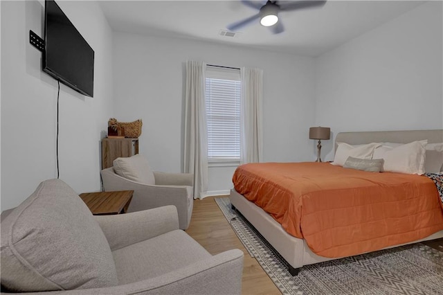 bedroom with ceiling fan and light hardwood / wood-style flooring