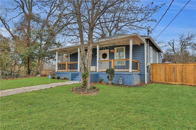 bungalow-style house featuring covered porch and a front lawn