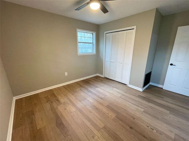 unfurnished bedroom featuring light hardwood / wood-style floors, a closet, and ceiling fan