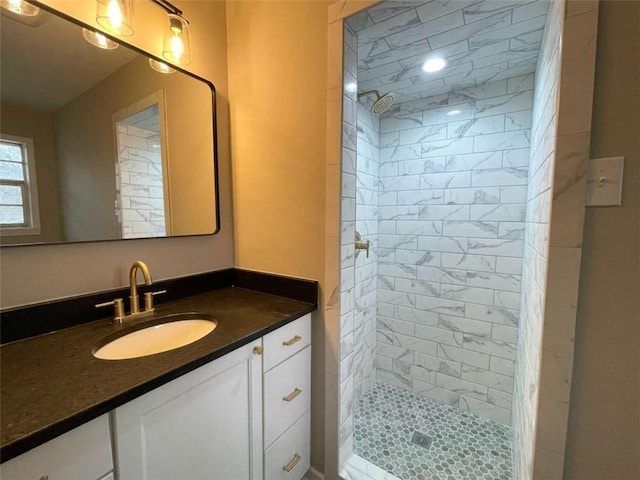 bathroom featuring vanity and tiled shower