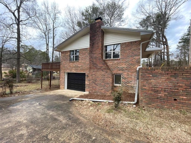 view of home's exterior featuring a garage and a deck