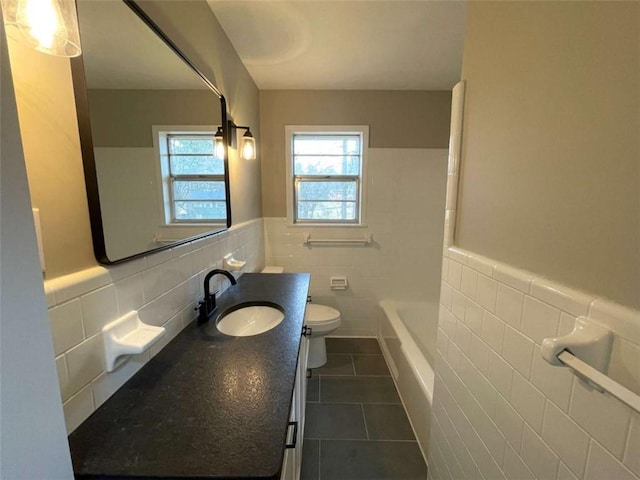 bathroom featuring vanity, tile walls, tile patterned floors, and toilet