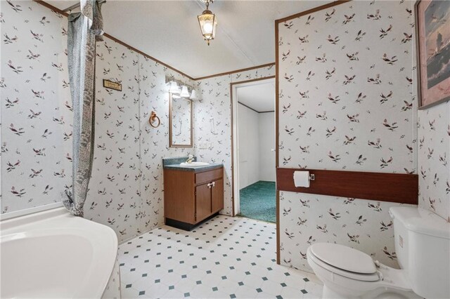 bathroom featuring vanity, wallpapered walls, crown molding, toilet, and tile patterned floors