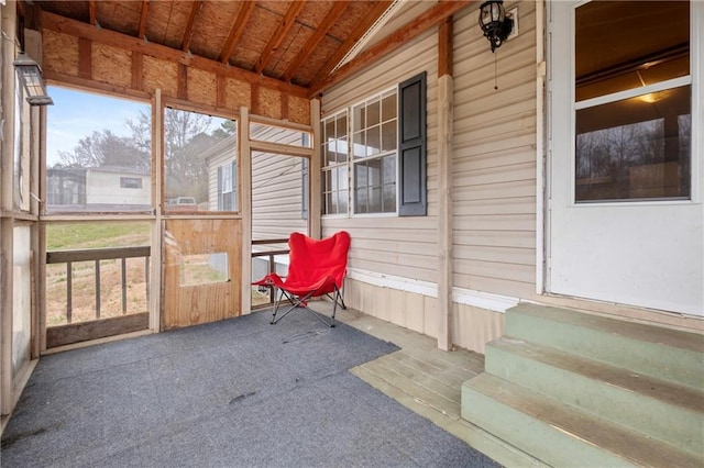 sunroom / solarium featuring lofted ceiling