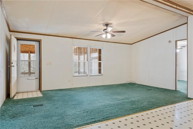 unfurnished room featuring visible vents, a ceiling fan, ornamental molding, and carpet flooring