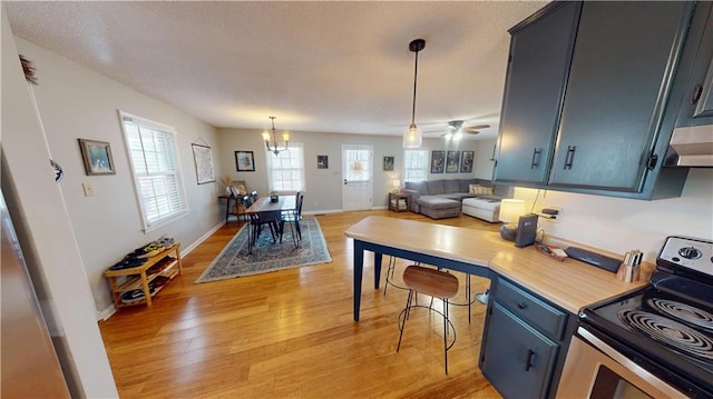 kitchen featuring light wood-type flooring, open floor plan, stainless steel electric range oven, and ventilation hood