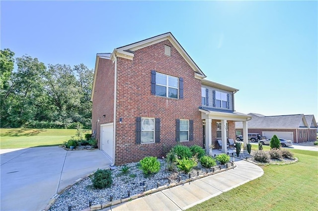 view of front facade with a garage, a front yard, brick siding, and driveway