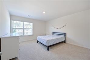 carpeted bedroom featuring baseboards