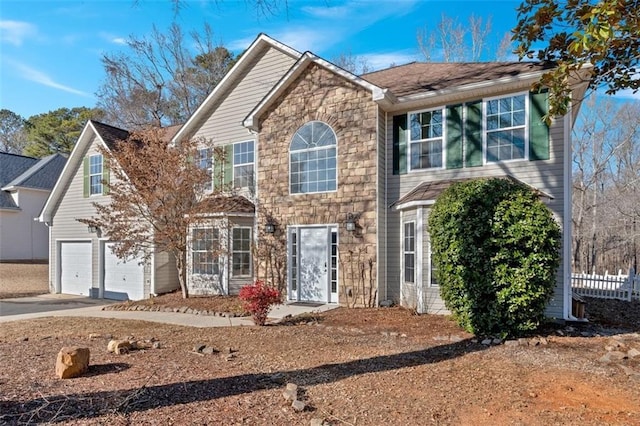 colonial house featuring a garage, stone siding, and concrete driveway