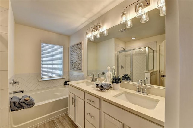 full bath featuring double vanity, a sink, a bath, and a shower stall