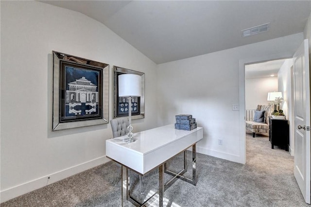 carpeted home office featuring lofted ceiling, baseboards, and visible vents