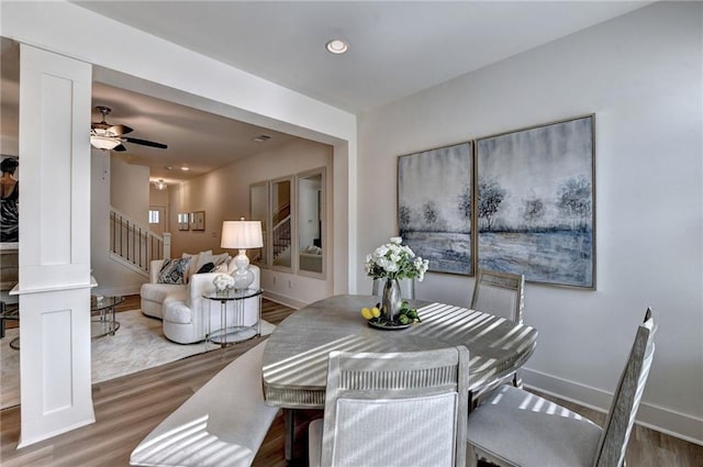 dining area with recessed lighting, wood finished floors, baseboards, and stairs