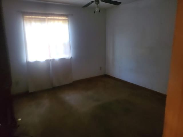 unfurnished room featuring a ceiling fan