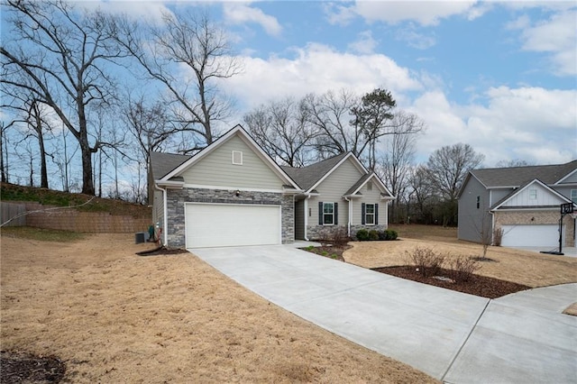 ranch-style house featuring stone siding, concrete driveway, fence, and an attached garage