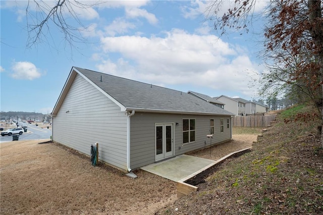 rear view of property featuring fence and a patio