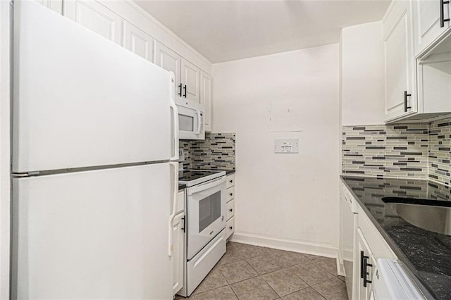 kitchen featuring tasteful backsplash, baseboards, light tile patterned floors, white appliances, and white cabinetry