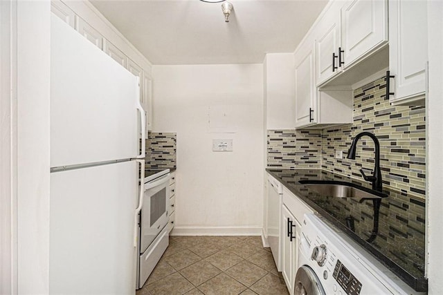 kitchen with light tile patterned floors, washer / clothes dryer, white appliances, white cabinetry, and a sink