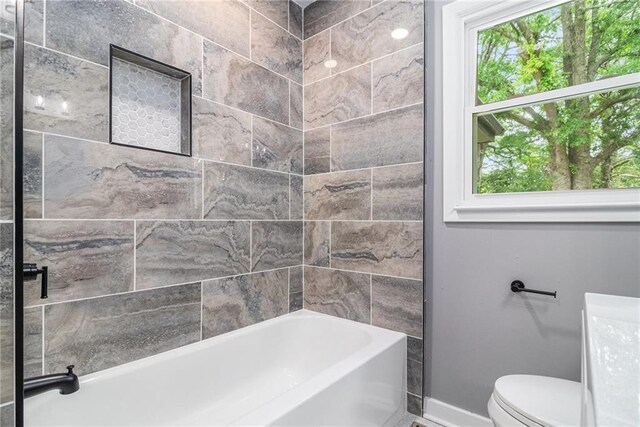 bathroom featuring toilet and baseboards