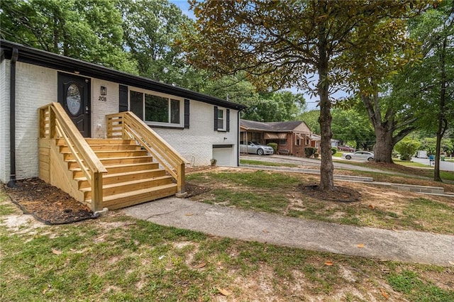 view of front of home with concrete driveway, brick siding, and a garage