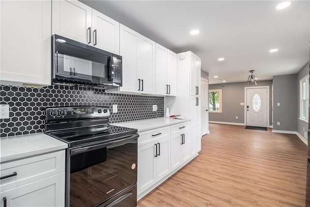 kitchen with decorative backsplash, light countertops, black appliances, recessed lighting, and light wood-style flooring