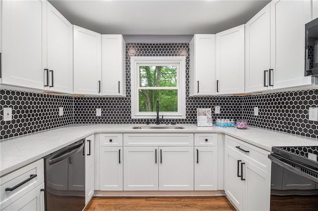 kitchen with white cabinets, electric range, a sink, dishwasher, and backsplash