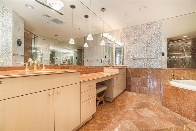 bathroom with vanity, tile walls, and shower with separate bathtub