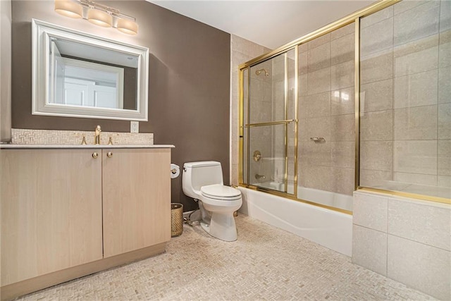 full bathroom with shower / bath combination with glass door, vanity, and toilet