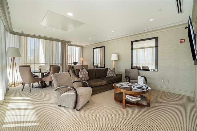 carpeted living room featuring ornamental molding