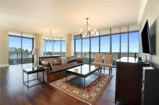 living room with dark wood-type flooring, an inviting chandelier, a wealth of natural light, and expansive windows