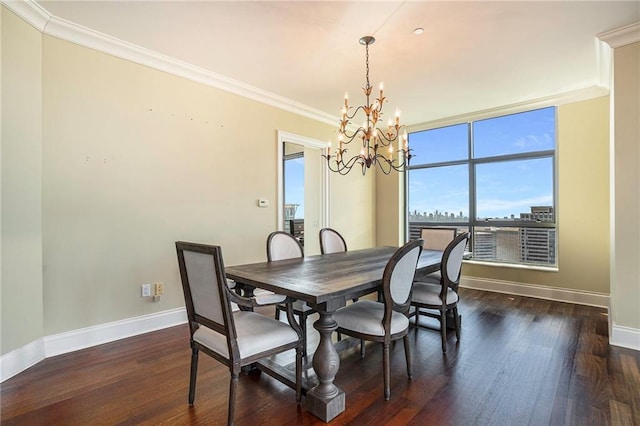 dining room with dark hardwood / wood-style floors, crown molding, and a chandelier