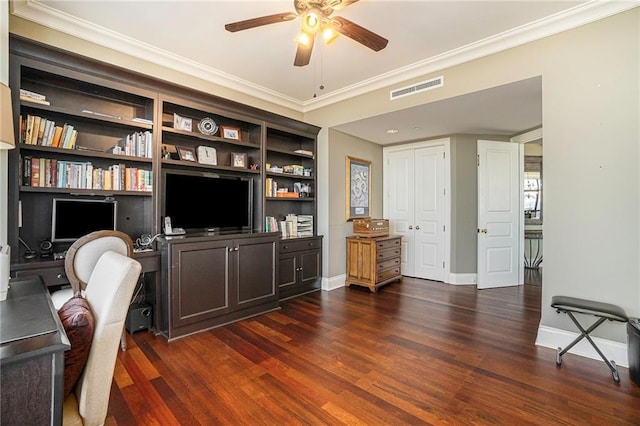 home office with ceiling fan, built in shelves, dark hardwood / wood-style flooring, and crown molding