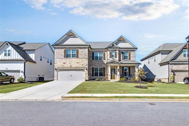 view of front of home with a front yard, central AC, and a garage