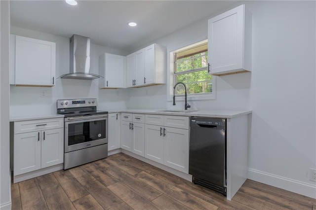 kitchen featuring white cabinetry, electric range, dishwasher, and wall chimney exhaust hood