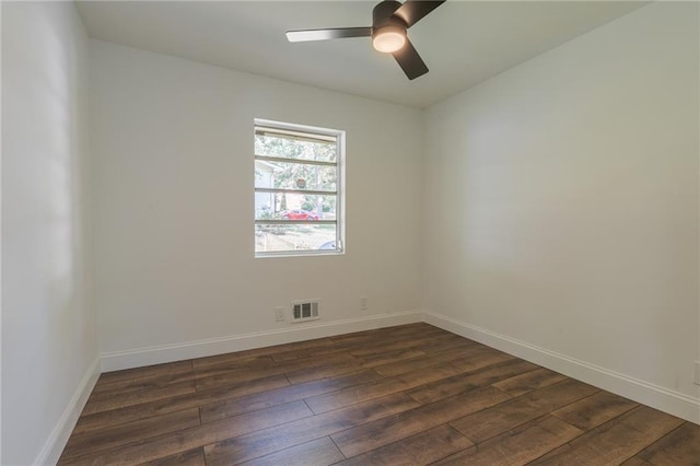 spare room featuring dark hardwood / wood-style floors and ceiling fan