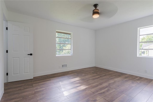 spare room with hardwood / wood-style floors and ceiling fan