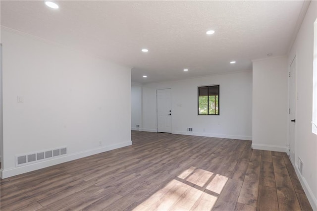 unfurnished room featuring wood-type flooring and ornamental molding