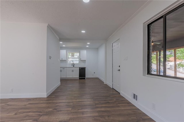 hallway with sink, crown molding, dark wood-type flooring, and a textured ceiling