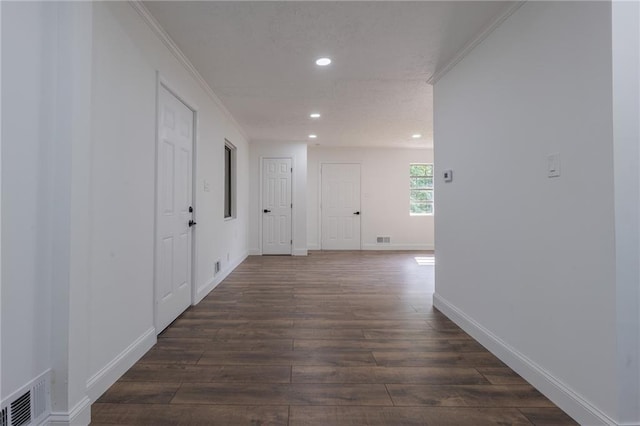 hallway featuring dark hardwood / wood-style flooring and ornamental molding