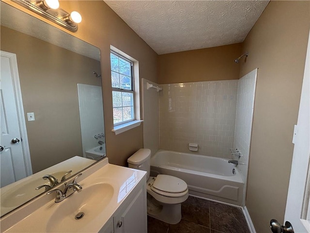 full bathroom with toilet, tiled shower / bath, a textured ceiling, vanity, and tile patterned flooring