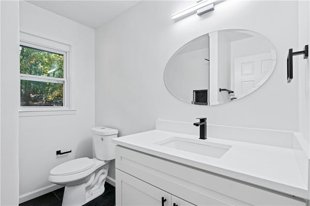 bathroom featuring tile patterned flooring, vanity, and toilet