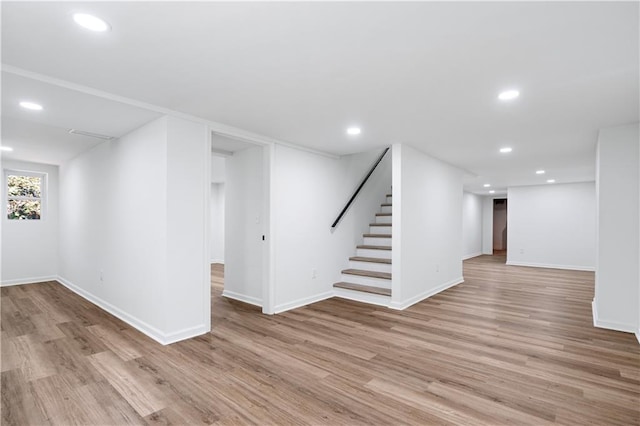 basement with light hardwood / wood-style floors