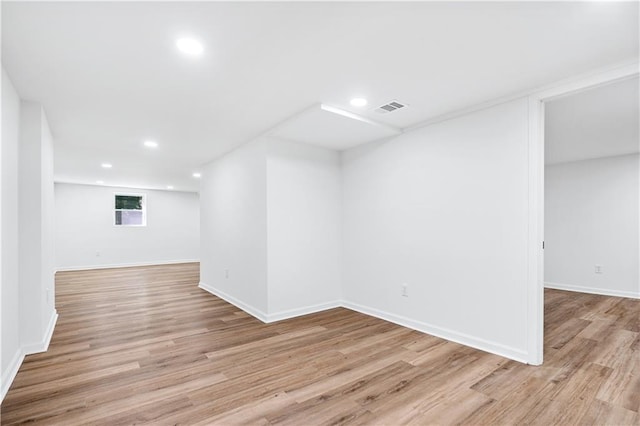 basement with light hardwood / wood-style floors