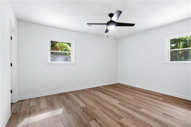 empty room featuring ceiling fan and light hardwood / wood-style floors