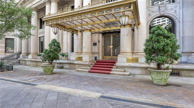 entrance to property featuring stone siding and a pergola