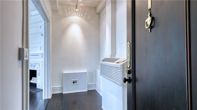 corridor with dark hardwood / wood-style flooring