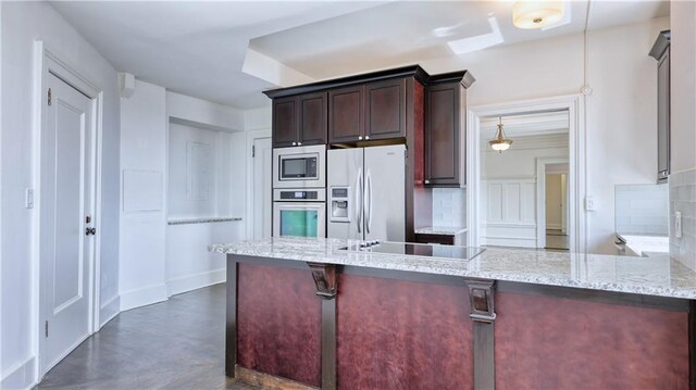 kitchen featuring decorative backsplash, stainless steel appliances, light stone counters, and kitchen peninsula