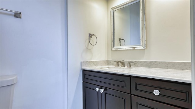 bathroom featuring toilet and vanity