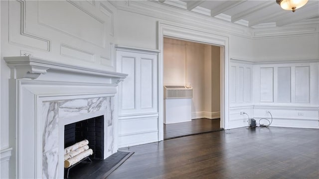 unfurnished living room featuring dark hardwood / wood-style flooring, beam ceiling, crown molding, and a high end fireplace